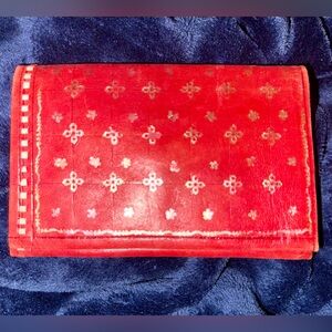 Red soft leather wallet with embossed gold pattern detail
